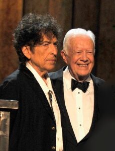 LOS ANGELES, CA - FEBRUARY 06: (L-R) Honoree Bob Dylan, former President Jimmy Carter and president of the National Academy of Recording Arts and Sciences Neil Portnow pose with award onstage at the 25th anniversary MusiCares 2015 Person Of The Year Gala honoring Bob Dylan at the Los Angeles Convention Center on February 6, 2015 in Los Angeles, California. The annual benefit raises critical funds for MusiCares' Emergency Financial Assistance and Addiction Recovery programs. For more information visit musicares.org. (Photo by Lester Cohen/WireImage